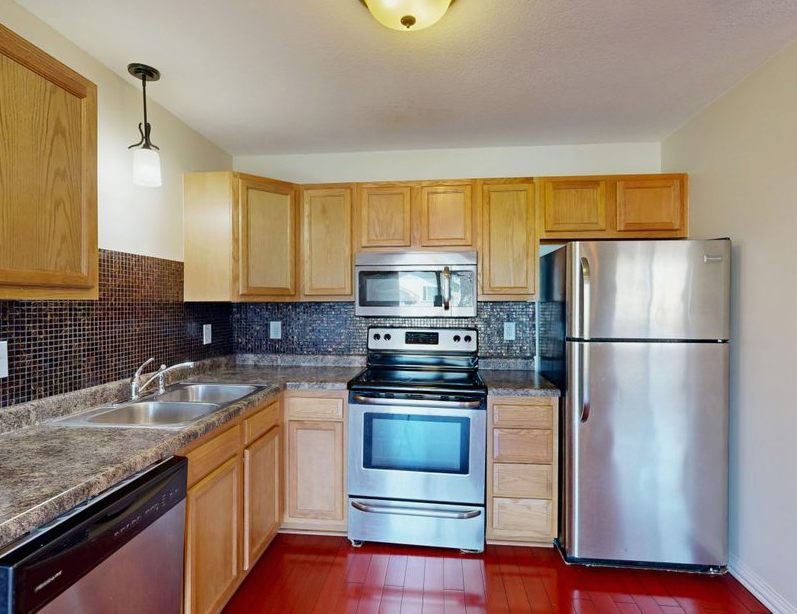 Kitchen Flooring Installation, contemporary kitchen featuring stainless steel appliances and wooden cabinetry